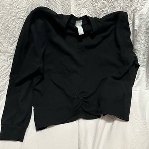 A simple black sweatshirt with a tuck folded design